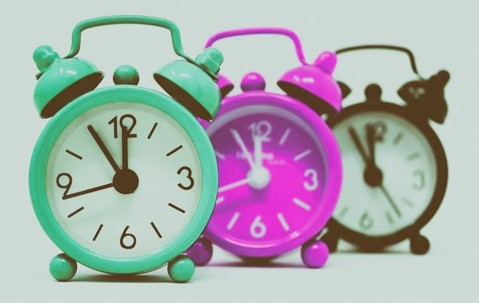 Vibrant set of vintage alarm clocks in teal, pink, and black.